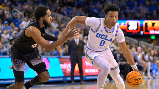 UCLA Bruins guard Jaylen Clark dribbles past Washington Huskies guard PJ Fuller II.